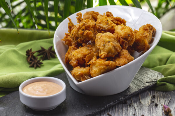 grilled chicken nuggets in the bowl crackers spices and sauce side view CHICKEN 65