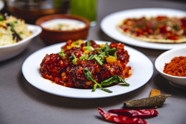 side-view-stewed-meatballs-with-tomato-sauce-bell-pepper-spring-onion-mint-plate CHILLY CHICKEN